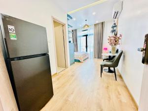 a living room with a refrigerator and a table at Myla House in Ho Chi Minh City