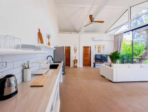 a living room with a white couch and a table at v27 Sunset Horizon Villa Seaview in Haad Yao