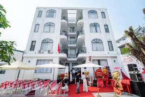 a group of people standing in front of a building at Cát Boutique Hotel in Dong Hoi +26 photos