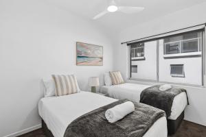 a bedroom with two beds and a window at Ocean Spray 5 in Coffs Harbour