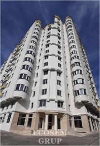 a large white apartment building with a sign on it at Fine Boutique Apartment in Chişinău