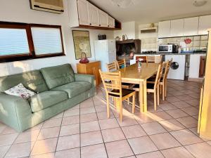 a living room with a green couch and a table at Casa Barbara in Sant Arcangelo