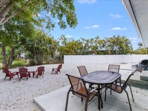 a patio with a table and chairs on the beach at Beach and Boaters Delight! in Fort Myers Beach