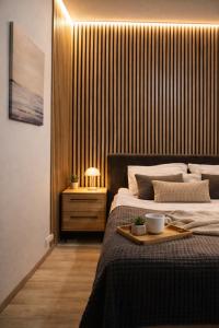 a bedroom with a bed with a tray on it at Nordic Dream Apartment in Kikinda in Kikinda