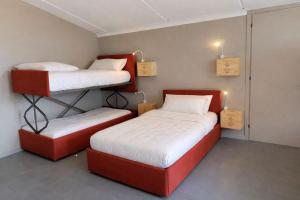 two bunk beds in a room with two beds at Lodge Valchiavenna in Verceia