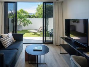 a living room with a couch and a table at Quest Robina in Gold Coast