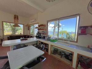 a kitchen with a counter and a table with chairs at Durano Seaside Retreat in Mercedes
