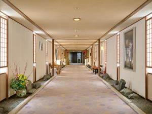 a hallway of a building with a walkway at Oyado Kiyomizuya in Noboribetsu