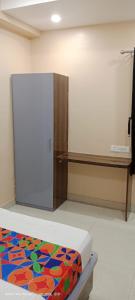 a room with a bed and a refrigerator at Hotel royale in Kolkata