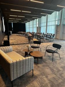 a room with tables and chairs in a building at Casino 2000 - Adult Guests Only in Mondorf-les-Bains