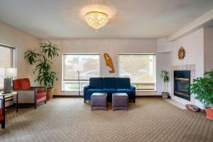 a waiting room with a blue couch and chairs at Comfort Inn & Suites Salem Northeast in Salem