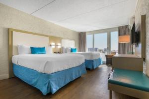 a hotel room with two beds and a large window at Inn on Destin Harbor, an Ascend Collection Hotel in Destin +57 photos