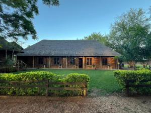 a wooden house with a fence in front of it at Lapa Lê Lê Lodge in Ellisras