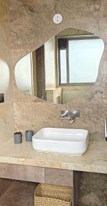 a bathroom with a sink and a mirror at Zumi Stays in Udaipur +13 photos