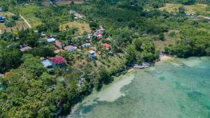 an aerial view of a house on an island next to the water at Durano Seaside Retreat in Mercedes