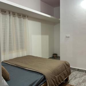 a bedroom with a bed in a room at Simba Stay's 2BHK in Chikmagalūr