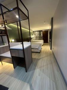 a bedroom with a bunk bed and a large mirror at May Three Farm in Puerto Galera +12 photos