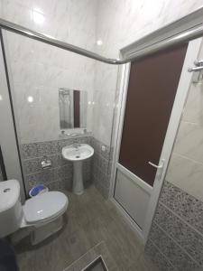 a bathroom with a shower and a toilet and a sink at Bilol Guest House in Samarkand +16 photos