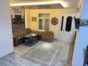 a living room with a couch and a table at Bilol Guest House in Samarkand