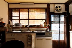 a kitchen with a sink and a window at Guest House Kura in Suzaka +20 photos