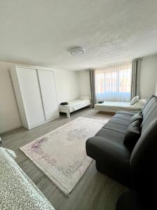 a living room with a couch and a rug at Apartman Stari Grad in Cazin +18 photos