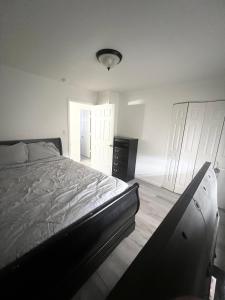 a bedroom with a bed and a room with white walls at Renovated Downtown Phoenix Condo in Phoenix