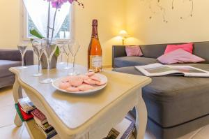 a table with a plate of food and a bottle of wine at L'olifred in Mathaux +8 photos