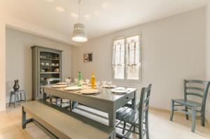a dining room with a table and chairs at L'olifred in Mathaux