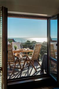 a patio with a table and chairs on a balcony at Visit Nida Apartments in Nida
