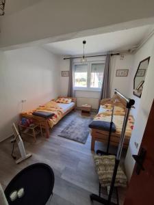 a small room with two beds and a window at Konak kod Daće in Drvar