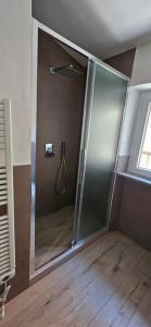 a shower with a glass door in a bathroom at Blue Living -Archi di Mare in Marciana Marina +11 photos