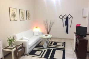 a living room with a white couch and a table at Lorenzo Magnifico Apartment in Rome