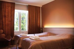 a hotel room with two beds and a window at EC-Hostel in Vaasa