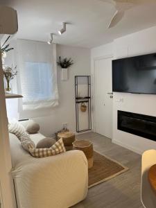 a living room with a couch and a fireplace at Apartamento con WiFi y Aire acondicionado en Pals Playa in Pals
