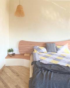 a bedroom with a bed with a wooden headboard at Zumi Stays in Udaipur