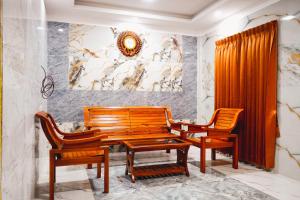 a dining room with two chairs and a wooden table at Sumiwhitehouse in Vallam