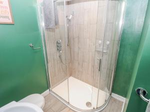 a shower stall in a bathroom with a toilet at The Granary in Ripon +18 photos