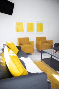 a living room with a couch and two chairs at Bombarda 51 - Inn & Hostel in Vila Praia de Âncora