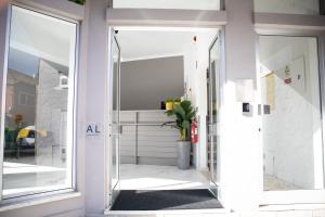 an open glass door with a potted plant at Bombarda 51 - Inn & Hostel in Vila Praia de Âncora +64 photos