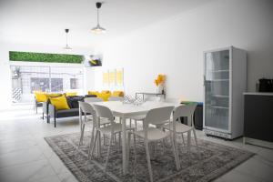 a dining room with a white table and chairs at Bombarda 51 - Inn & Hostel in Vila Praia de Âncora