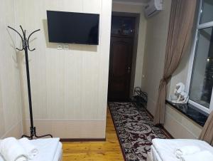 a room with a flat screen tv on the wall at Bilol Guest House in Samarkand