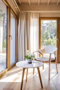 a living room with a table and a chair at Valle Benedetta Retreat Center in Livorno