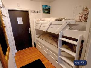 a bedroom with two bunk beds and a hallway at Fewo Eisvogelnest in Sankt Englmar +22 photos
