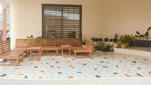 a patio with wooden tables and chairs and plants at Zumi Stays in Udaipur