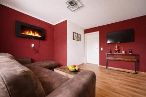 a living room with a couch and a fireplace at Ferienwohnung Penny-Ranch in Zethau