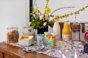 a table with food and other items on it at Ecovillage Sanctuary Bordei in Palagnedra