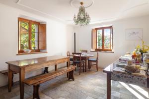 a living room with a table and a dining room at Ecovillage Sanctuary Bordei in Palagnedra
