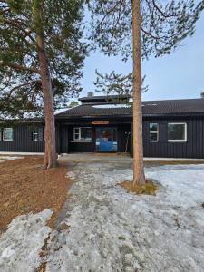 a house with two trees in front of it at Alta Folkehøgskole in Alta