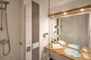 a bathroom with two sinks and a shower at Luna Inn Stuttgart City in Stuttgart +43 photos