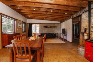 a living room with a wooden table and chairs at Stony Rise Ranch in Pelican Lagoon +19 photos